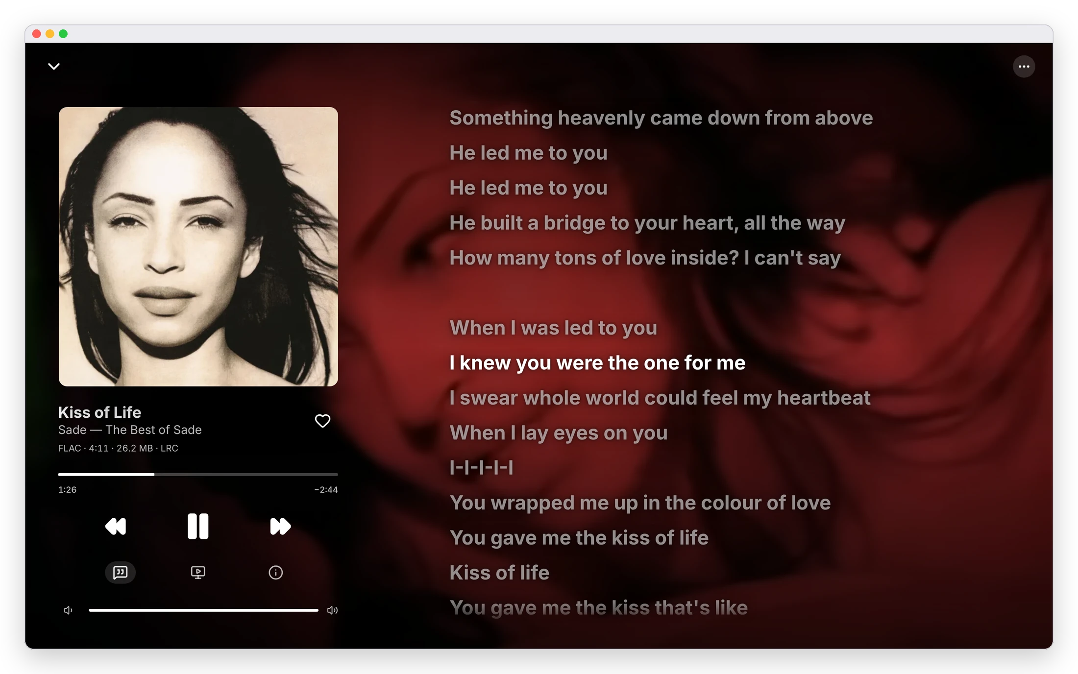 Now Playing on the desktop: Sade's Kiss of Life with its time-synced lyrics over the song's muted music video, the current line highlighted, and the cover and transport controls on the left